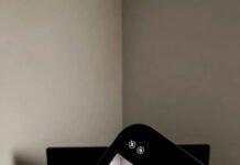 Why Content Optimization Should Be Your Top Priority Tilted phone selfie of a messy work desk: open laptop, mug, cables everywhere.