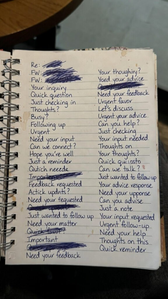 Awkward overhead shot of worn notebook showing crossed-out cold email subjects and coffee rings.